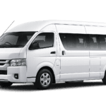 Toyota Hiace Commuter Luxury putih tampak serong depan dan samping untuk layanan sewa Hiace Luxury Bandung dengan driver profesional