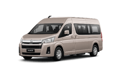 Toyota Hiace Premio Luxury coklat muda metallic tampak serong depan dan samping untuk layanan sewa Hiace Luxury Bandung dengan driver profesional